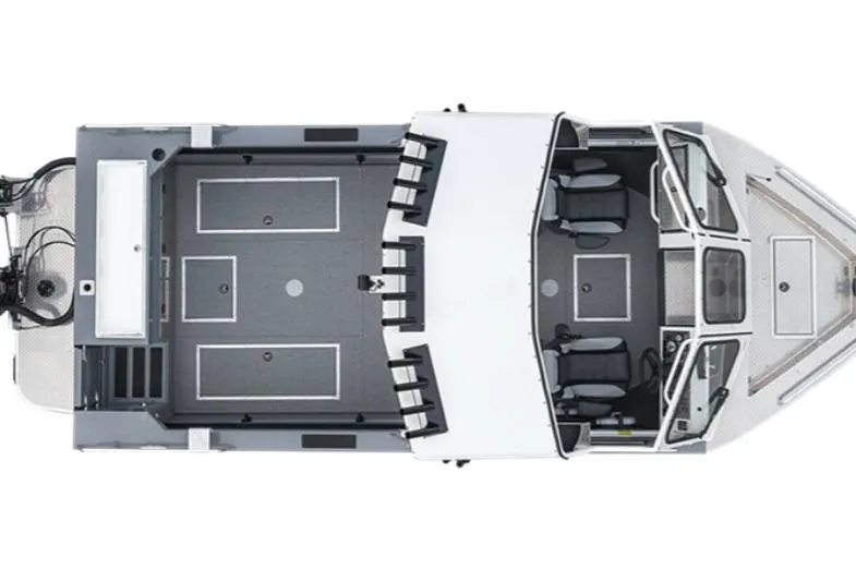 Slide: The Image of 2026 Lund 210 Heavy Gauge boat with diamond plate deck in a showroom. - 2