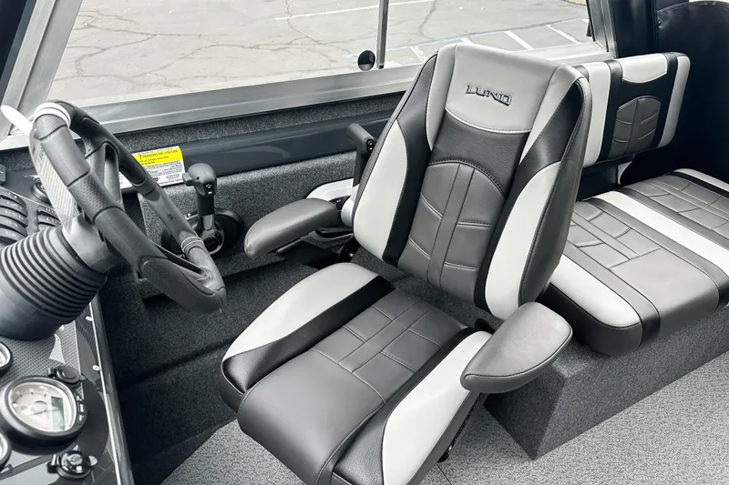 Slide: The Image of 2026 Lund 210 Heavy Gauge boat interior with modern steering and seating. - 23