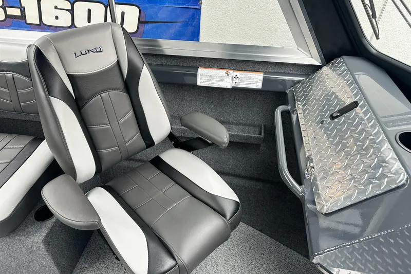 Slide: The Image of Interior of 2026 Lund 210 Heavy Gauge boat with black and gray seating. - 24