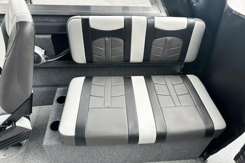 Slide: The Image of 2026 Lund 210 Heavy Gauge boat interior with black and white cushioned seating. - 29