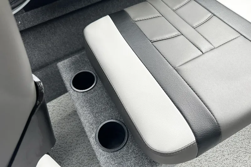 Slide: The Image of 2026 Lund 210 Heavy Gauge boat seat with dual cup holders, featuring gray and black upholstery. - 30