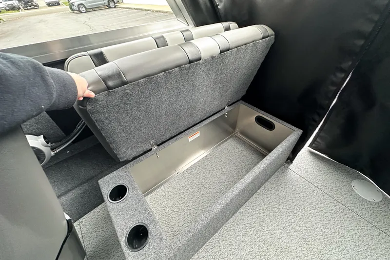 Slide: The Image of 2026 Lund 210 Heavy Gauge boat with open storage compartment under seat. - 31