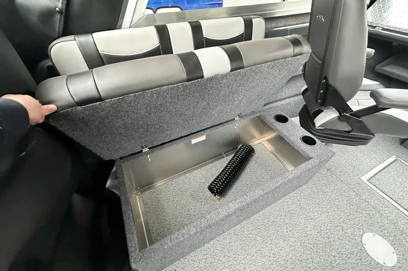 Slide: The Image of 2026 Lund 210 Heavy Gauge boat interior with under-seat storage compartment open. - 32