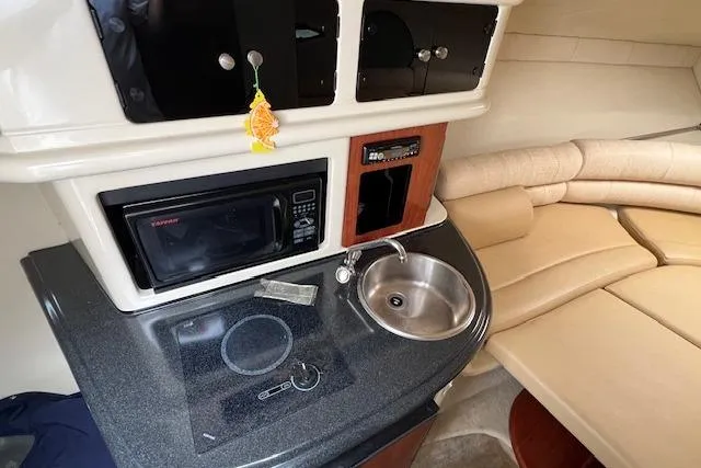 Slide: The Image of Interior of 2006 Monterey 250 Cruiser with kitchenette and seating area. - 10