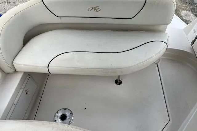 Slide: The Image of 2006 Monterey 250 Cruiser boat interior with white seating and floor. - 4