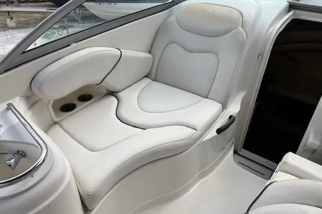 Slide: The Image of 2006 Monterey 250 Cruiser interior with white leather seating and cup holders. - 5
