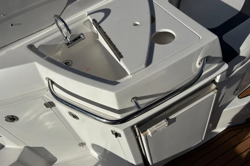 Slide: The Image of 2016 Monterey 295 Sport Yacht kitchenette with sink and storage. - 18