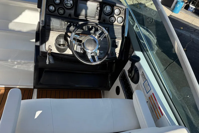 Slide: The Image of Cockpit of 2016 Monterey 295 Sport Yacht with steering wheel and control panel. - 19
