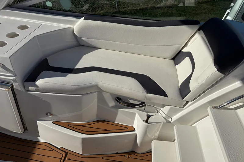 Slide: The Image of Luxury seating on 2016 Monterey 295 Sport Yacht with cup holders and teak flooring. - 20