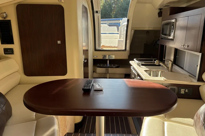 Slide: The Image of Interior of a 2016 Monterey 295 Sport Yacht with kitchen and dining area. - 26