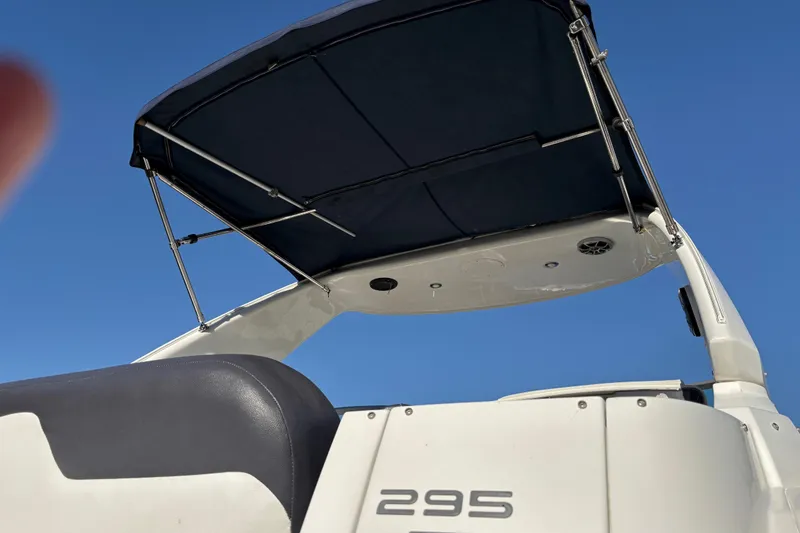 Slide: The Image of 2016 Monterey 295 Sport Yacht with canopy against clear blue sky. - 27