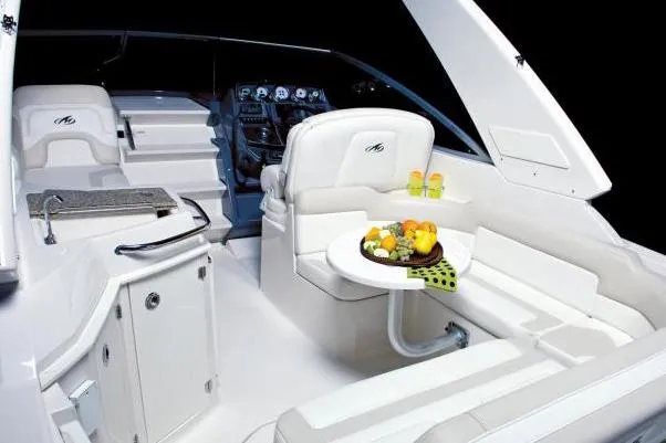 Slide: The Image of 2016 Monterey 295 Sport Yacht with sleek design, docked outdoors under clear blue sky. - 3