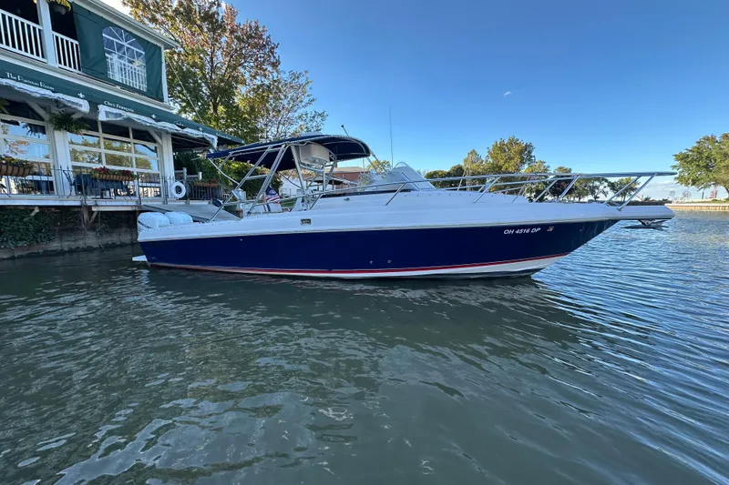 The Image of 1999 Intrepid 339 boat docked by a waterfront restaurant. - 0