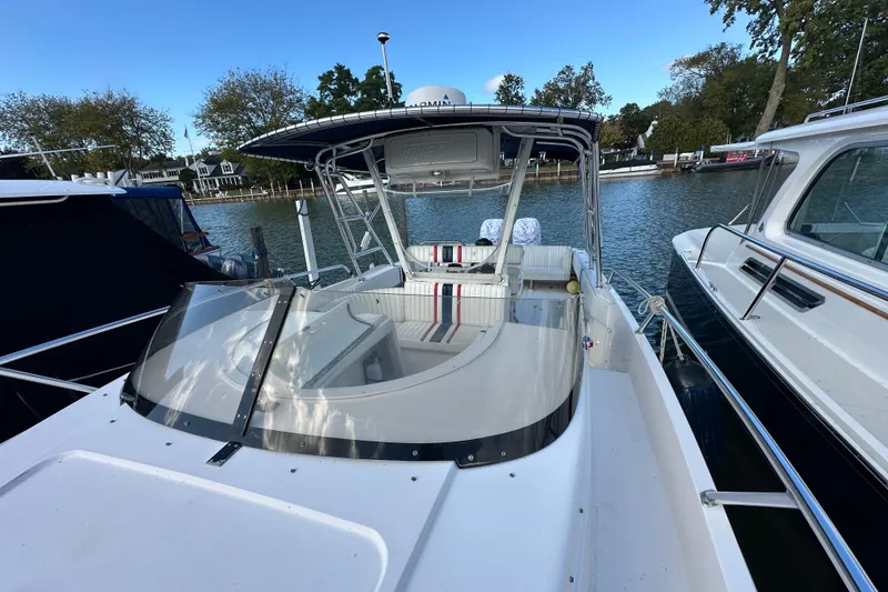 Slide: The Image of 1999 Intrepid 339 boat docked, featuring sleek design and spacious seating area. - 10