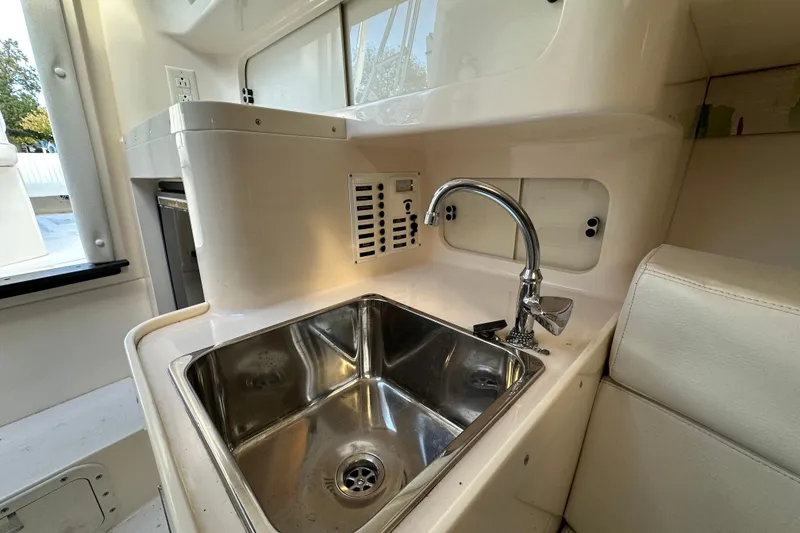 Slide: The Image of 1999 Intrepid 339 boat interior with stainless steel sink and faucet. - 16