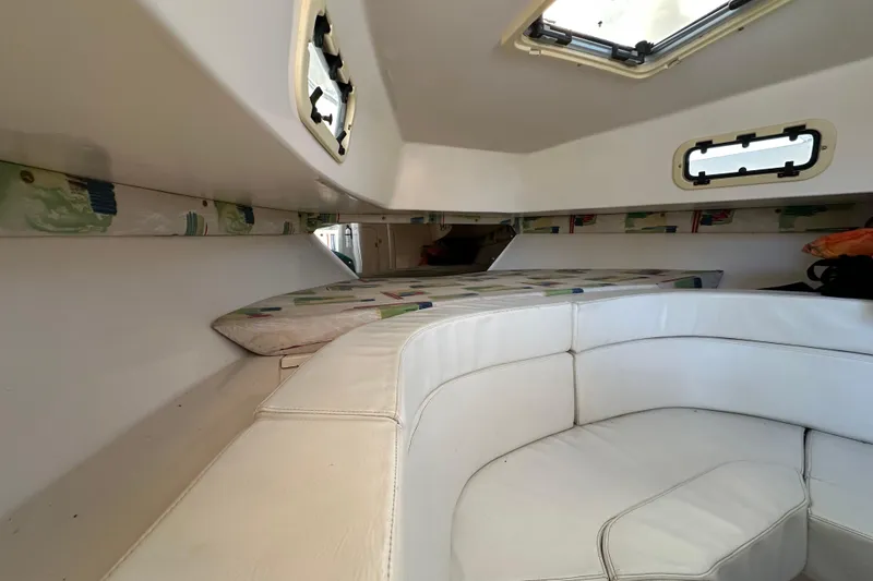 Slide: The Image of Interior of a 1999 Intrepid 339 boat with white cushioned seating. - 17