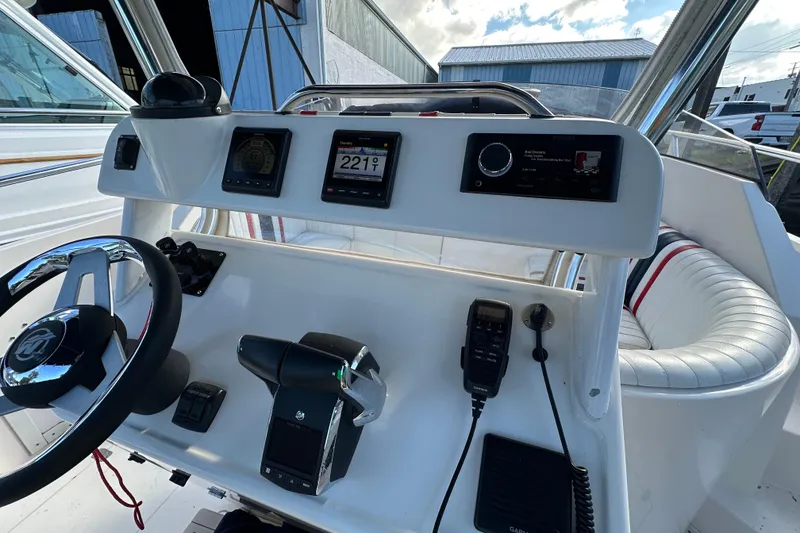 Slide: The Image of 1999 Intrepid 339 boat interior with white seating and red, blue stripes. - 2
