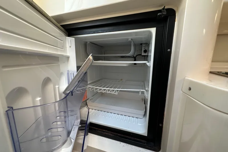 Slide: The Image of Control panel of a 1999 Intrepid 339 boat with labeled switches and voltmeter. - 20