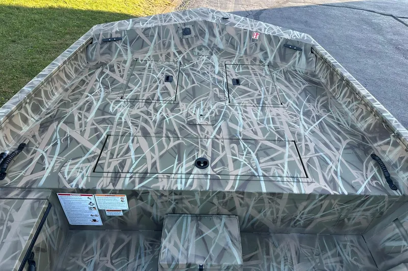 Slide: The Image of 2026 Lowe Roughneck 2070SC boat with camouflage pattern, featuring storage compartments and durable design. - 10