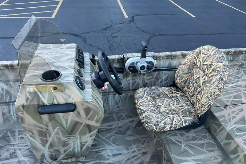 Slide: The Image of 2026 Lowe Roughneck 2070SC boat interior with camouflage seat and steering console. - 14