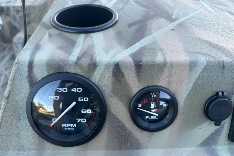 Slide: The Image of Dashboard of 2026 Lowe Roughneck 2070SC with RPM and fuel gauges. - 16