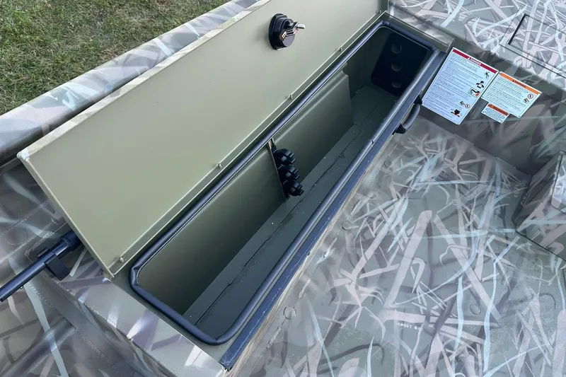 Slide: The Image of Open storage compartment in 2026 Lowe Roughneck 2070SC boat with camouflage design. - 19