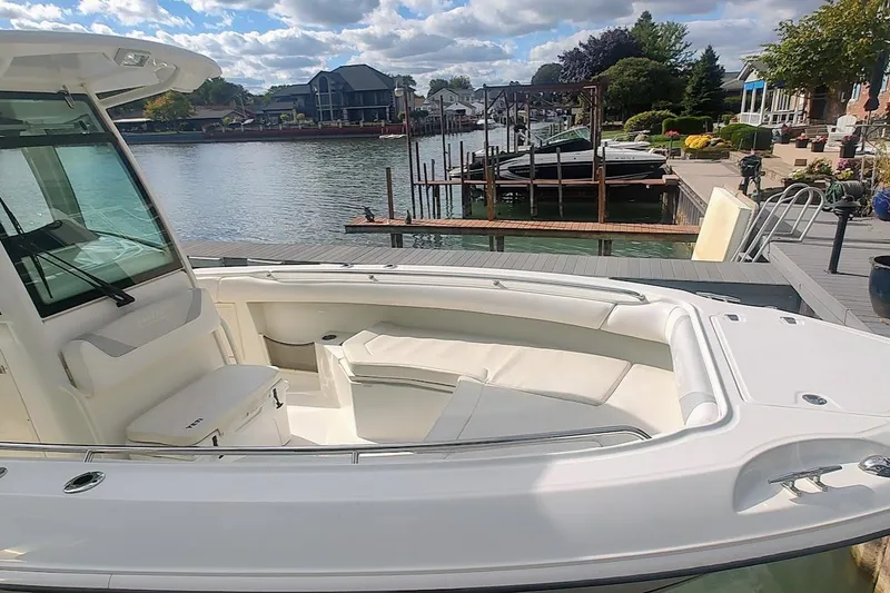 Slide: The Image of 2012 Boston Whaler 280 Outrage boat docked by a scenic waterfront. - 13