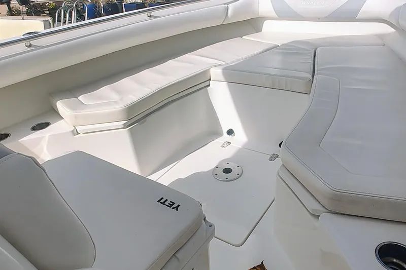 Slide: The Image of Interior of a 2012 Boston Whaler 280 Outrage boat with white cushioned seating. - 14