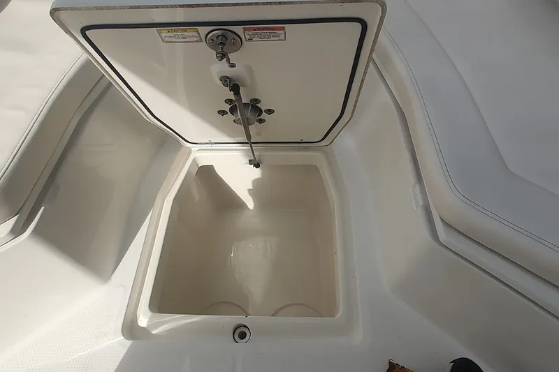 Slide: The Image of Open storage compartment on a 2012 Boston Whaler 280 Outrage boat deck. - 15