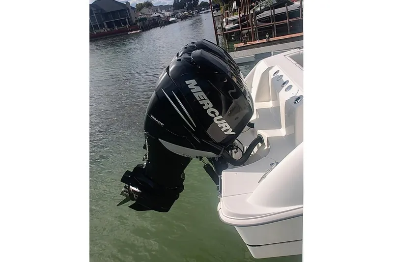 Slide: The Image of 2012 Boston Whaler 280 Outrage with Mercury outboard engine on a calm waterfront. - 22
