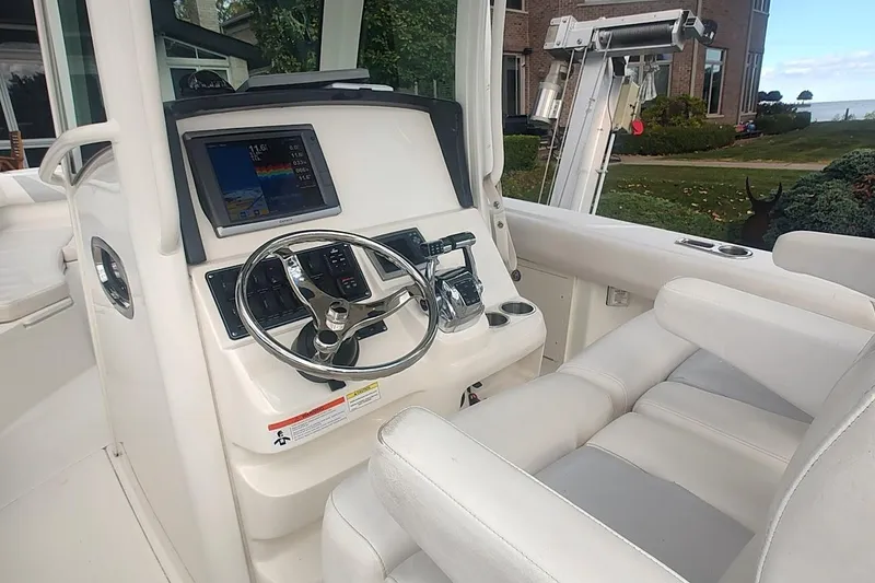 Slide: The Image of 2012 Boston Whaler 280 Outrage helm with steering wheel and navigation display. - 28