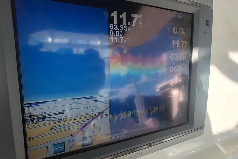 Slide: The Image of Garmin marine display on 2012 Boston Whaler 280 Outrage showing depth and navigation data. - 29