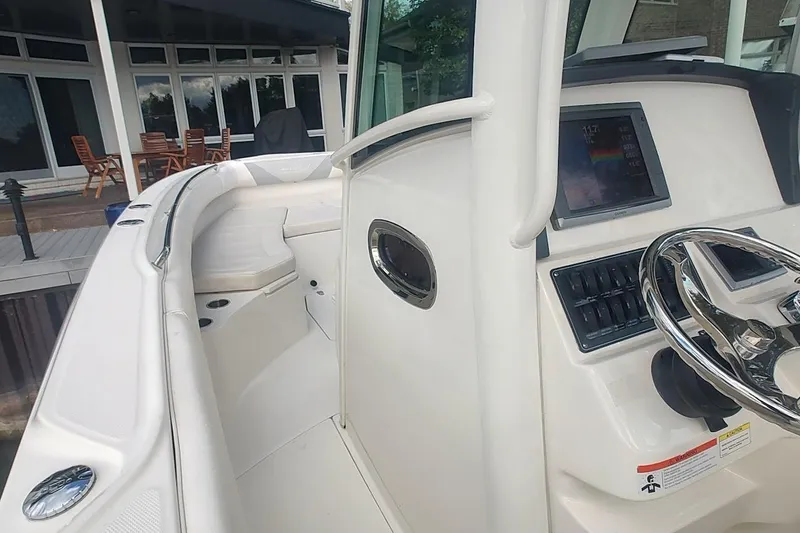 Slide: The Image of 2012 Boston Whaler 280 Outrage boat interior with steering wheel and control panel. - 30