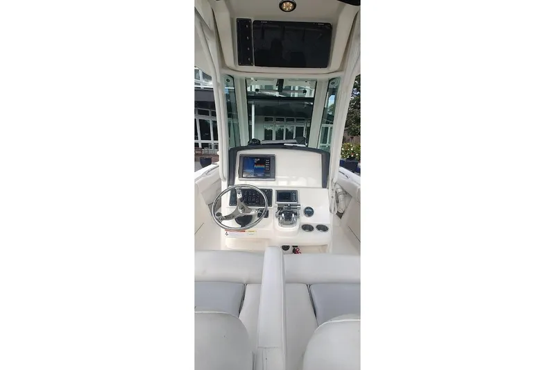Slide: The Image of 2012 Boston Whaler 280 Outrage helm with steering wheel and navigation display. - 31