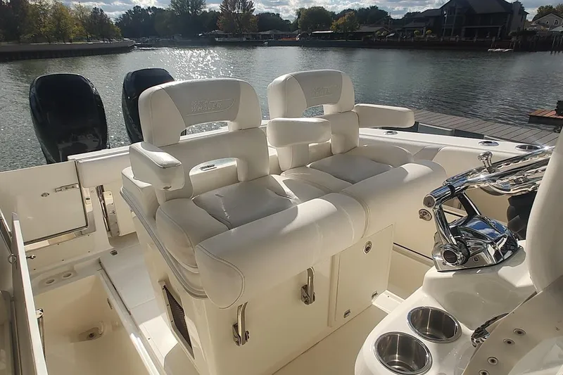 Slide: The Image of 2012 Boston Whaler 280 Outrage boat interior with white seating and dual engines. - 33