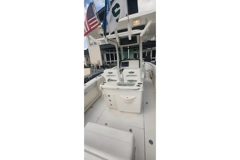 Slide: The Image of 2012 Boston Whaler 280 Outrage boat interior with flags and seating area. - 36