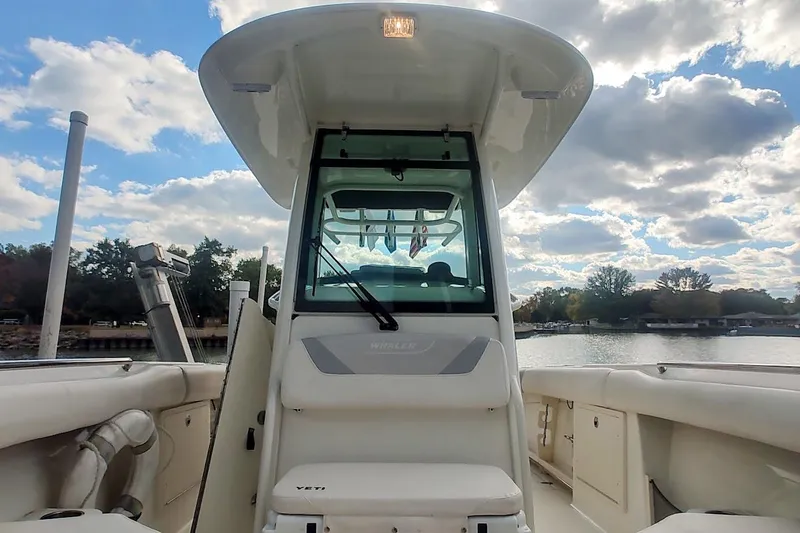 Slide: The Image of 2012 Boston Whaler 280 Outrage boat interior with clear sky and water view. - 39