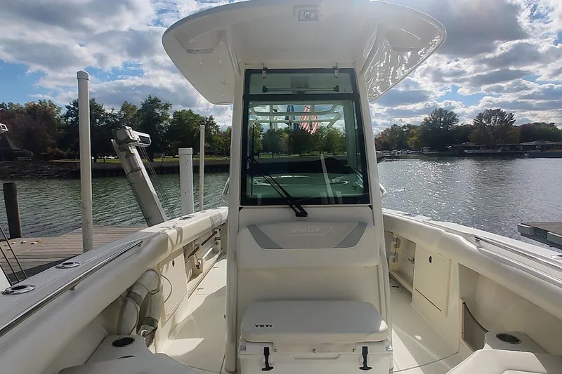 Slide: The Image of 2012 Boston Whaler 280 Outrage boat docked by a scenic lake under cloudy skies. - 40