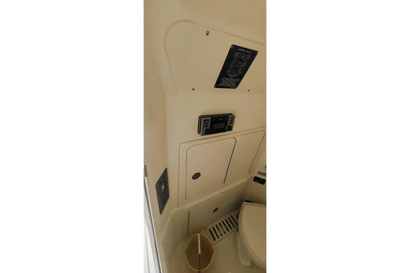 Slide: The Image of Interior view of 2012 Boston Whaler 280 Outrage boat's cabin with control panel. - 42