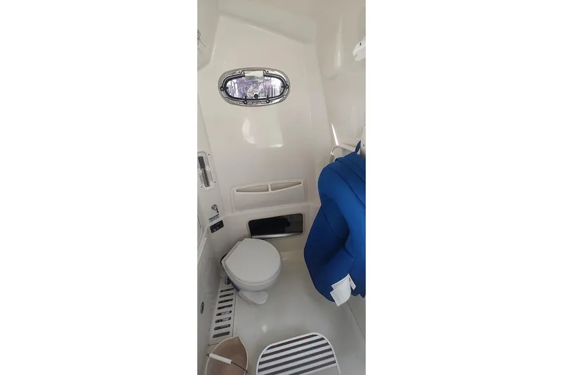 Slide: The Image of Interior of 2012 Boston Whaler 280 Outrage boat, featuring compact marine toilet. - 44