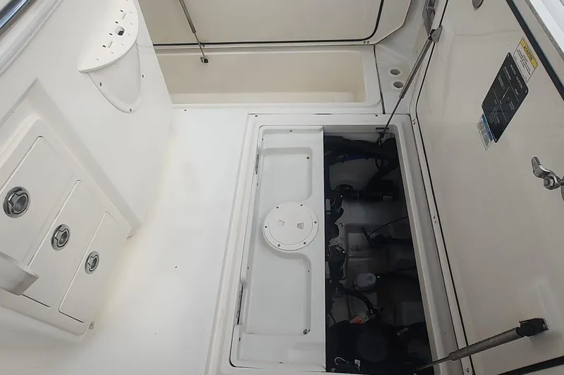 Slide: The Image of 2012 Boston Whaler 280 Outrage boat interior with open storage compartments. - 46