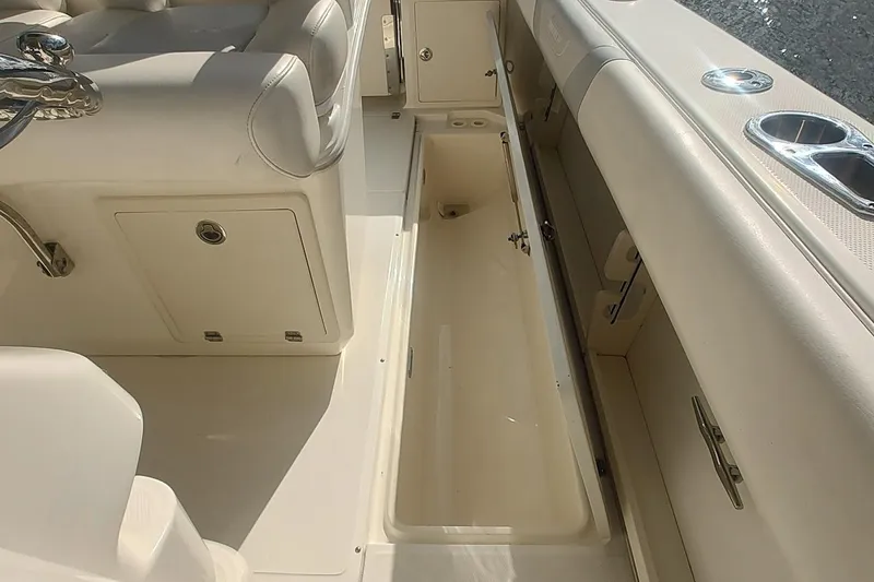 Slide: The Image of Interior view of a 2012 Boston Whaler 280 Outrage boat, featuring storage compartments. - 49
