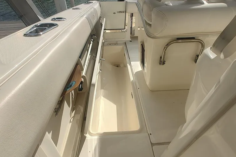 Slide: The Image of Interior view of a 2012 Boston Whaler 280 Outrage boat, showcasing storage compartments. - 50