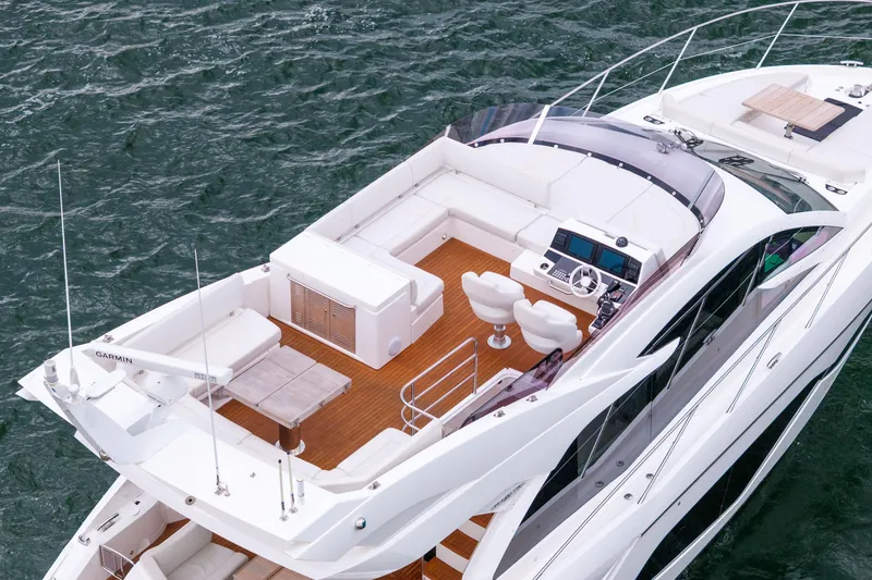 Slide: The Image of 2018 Sunseeker Manhattan 52 yacht with spacious flybridge and modern helm, cruising on water. - 11