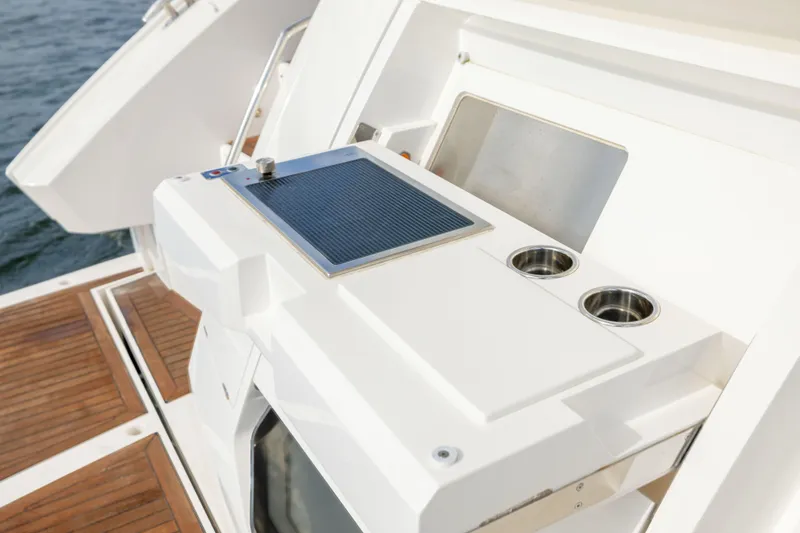Slide: The Image of Outdoor kitchen area on 2018 Sunseeker Manhattan 52 yacht with wooden deck. - 14