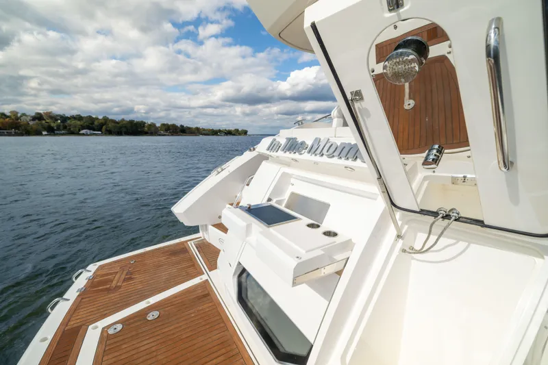 Slide: The Image of 2018 Sunseeker Manhattan 52 yacht on water, featuring sleek deck design and modern amenities. - 15