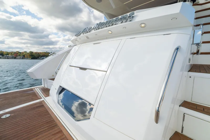Slide: The Image of 2018 Sunseeker Manhattan 52 yacht with sleek white exterior and wooden deck. - 16