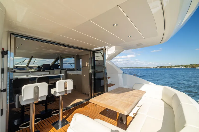 Slide: The Image of Luxurious 2018 Sunseeker Manhattan 52 yacht interior with ocean view and elegant seating area. - 18