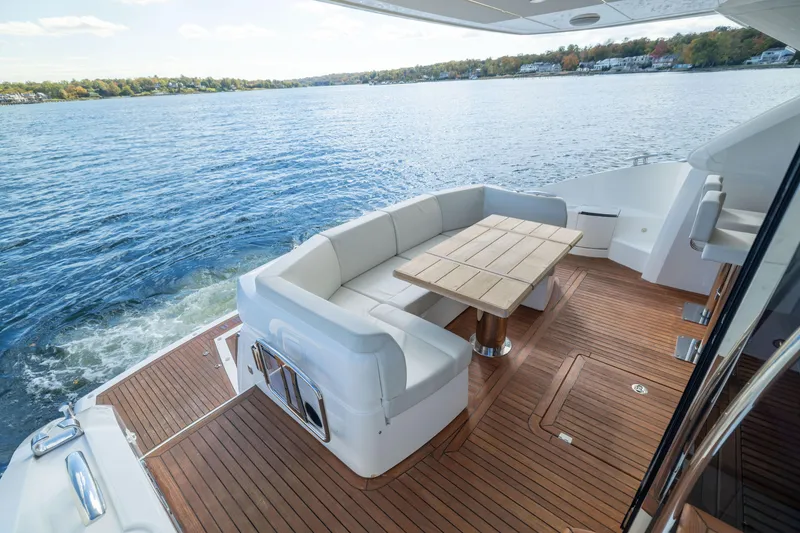Slide: The Image of Luxurious 2018 Sunseeker Manhattan 52 yacht deck with elegant seating and scenic water view. - 19