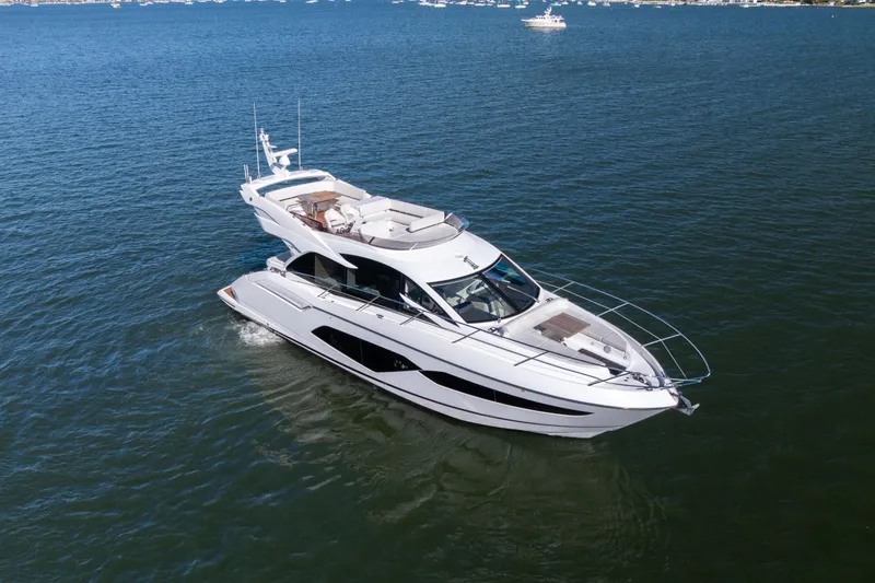 Slide: The Image of 2018 Sunseeker Manhattan 52 yacht cruising on open water. - 2